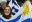 Girl with painted Uruguay flag on her cheek holding football flag with blue and white stripes and image of the sun